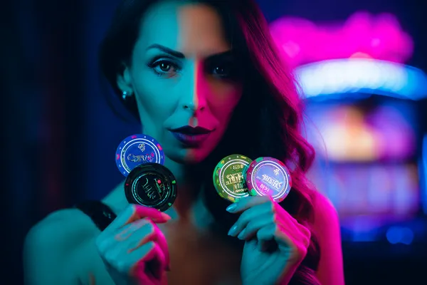 Uma mulher sorrindo perto de máquinas caça-níqueis brilhantes com símbolos de sorte, mostrando as emocionantes opções de slots do 61T.